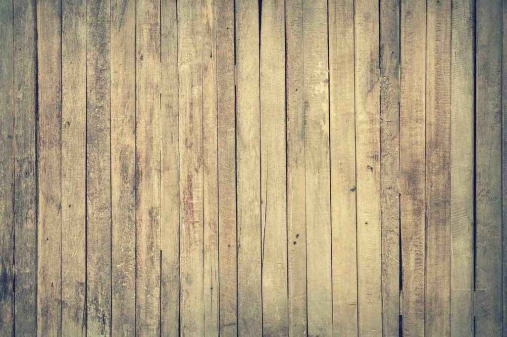 Rustic engineered wood floor with vertical planks in natural beige and brown tones.