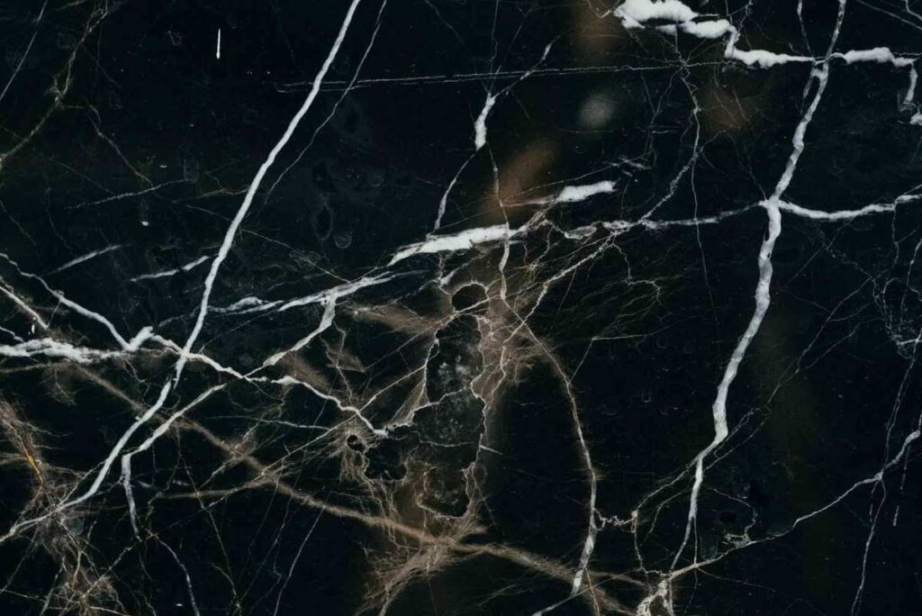 Black marble-look luxury vinyl flooring with white and gold veining pattern