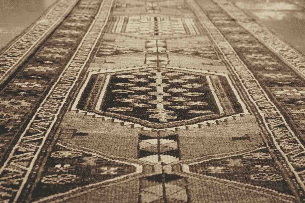 Traditional patterned carpet runner with geometric motifs in earthy tones