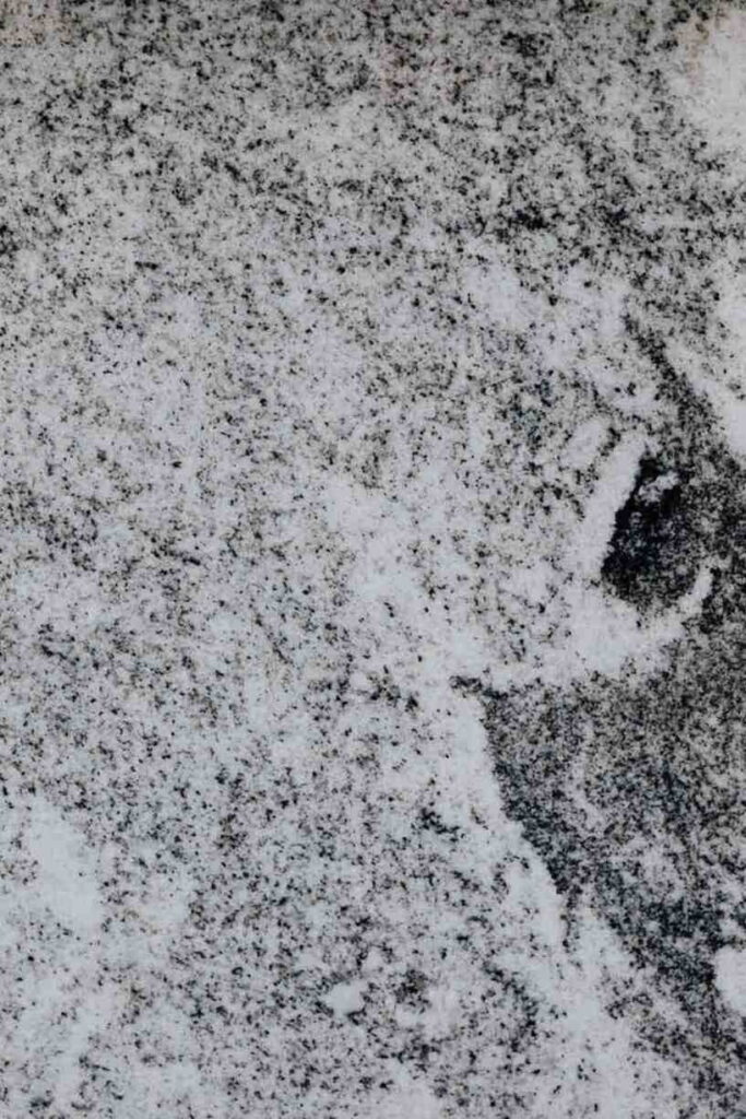 White granite-look luxury vinyl flooring with grey and black speckled patterns.