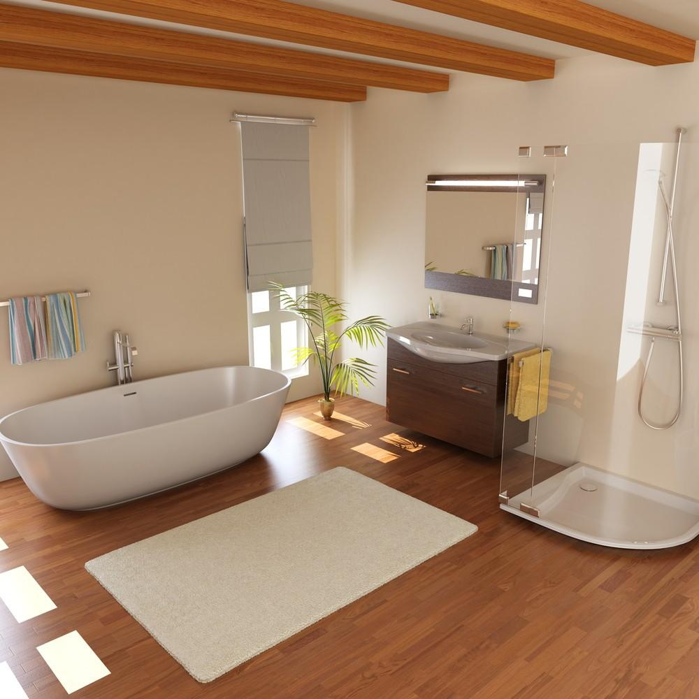 Bathroom interior with wood-look laminate flooring, freestanding bathtub, glass shower enclosure, vanity unit, and exposed wooden ceiling beams.