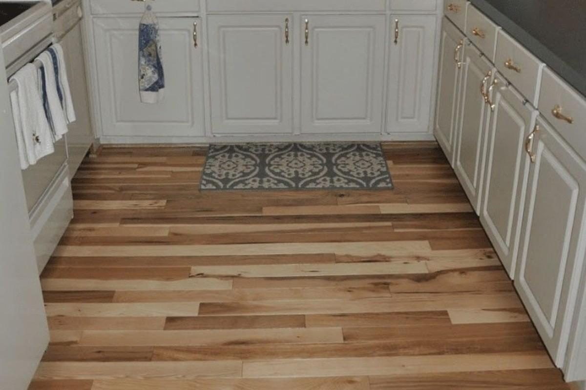 Kitchen interior with engineered wooden flooring in natural light and dark wood tones.